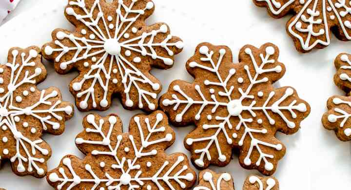 Gingerbread people-shaped cookies, with white icing decorations.